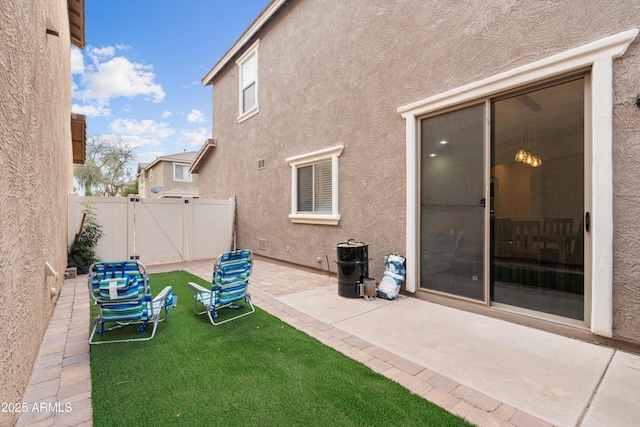 view of patio featuring a gate and fence