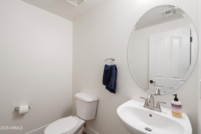 bathroom with visible vents, a sink, and toilet