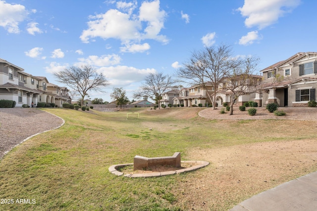 view of property's community with a residential view and a yard