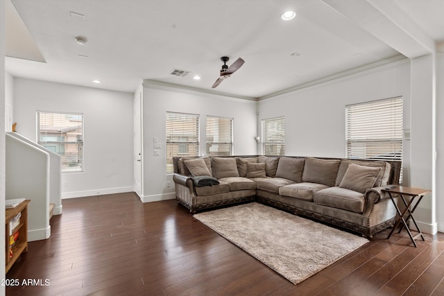 living room with dark wood-type flooring, a wealth of natural light, visible vents, and recessed lighting