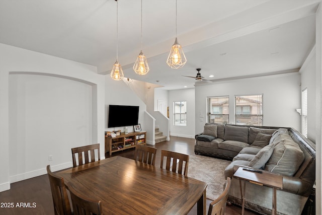 dining room featuring stairs, baseboards, dark wood finished floors, and a ceiling fan