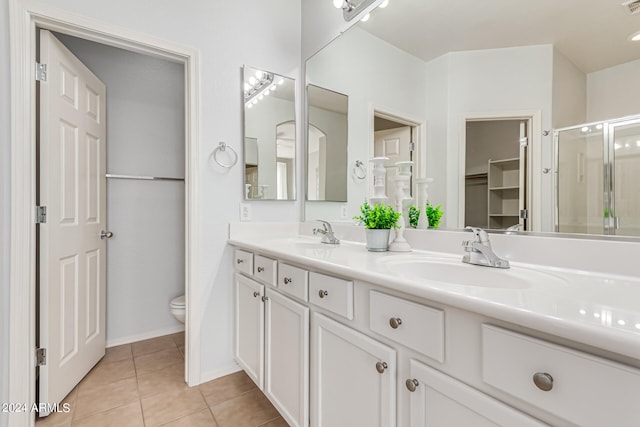 bathroom with vanity, toilet, tile patterned floors, and an enclosed shower