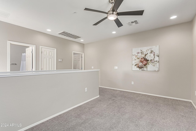 spare room with carpet and ceiling fan