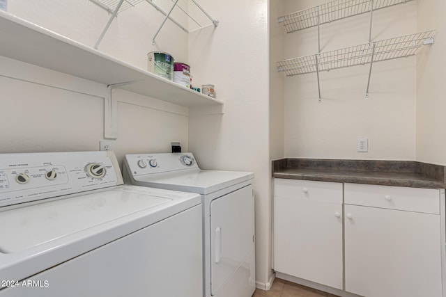 laundry room with light tile patterned floors and washing machine and clothes dryer