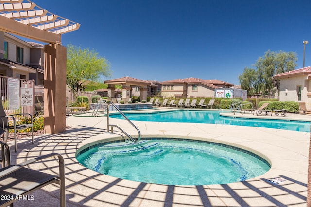 view of pool featuring a patio, a pergola, and a community hot tub