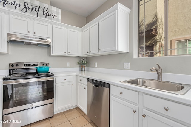 kitchen with stainless steel appliances, sink, and white cabinets