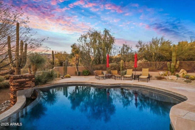 view of pool at dusk