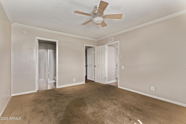 unfurnished bedroom with baseboards, a textured ceiling, ornamental molding, and carpet flooring