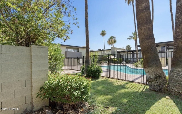 community pool featuring fence, a patio, and a lawn