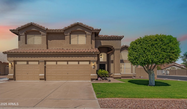 mediterranean / spanish-style house featuring a garage and a lawn