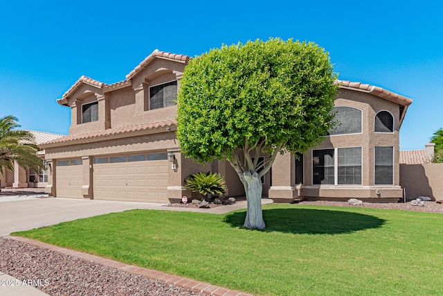 mediterranean / spanish-style home featuring a garage and a front yard