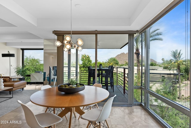 sunroom with a wealth of natural light and a chandelier