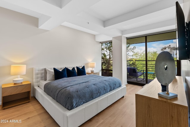 bedroom featuring beamed ceiling, light hardwood / wood-style floors, access to outside, and coffered ceiling