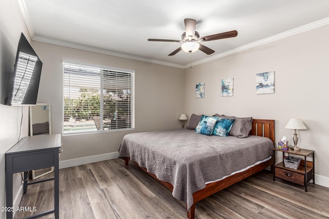bedroom featuring crown molding, baseboards, ceiling fan, and wood finished floors