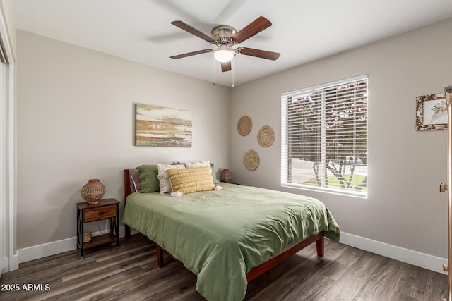bedroom with baseboards, ceiling fan, and wood finished floors