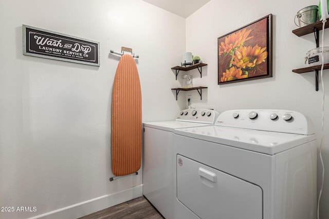 laundry area with washer and dryer, laundry area, baseboards, and dark wood-type flooring