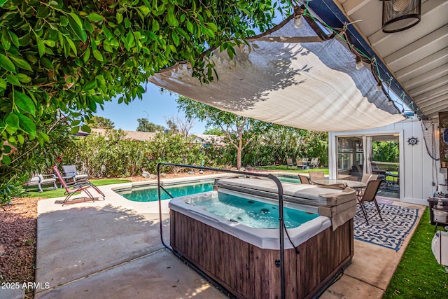 view of swimming pool with a hot tub and a patio area