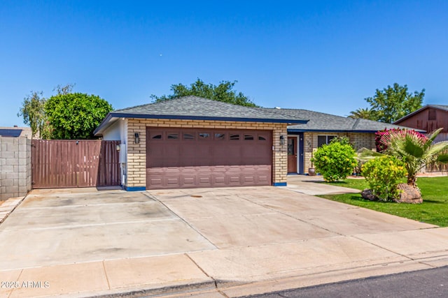 ranch-style home with a garage, a shingled roof, concrete driveway, and stone siding