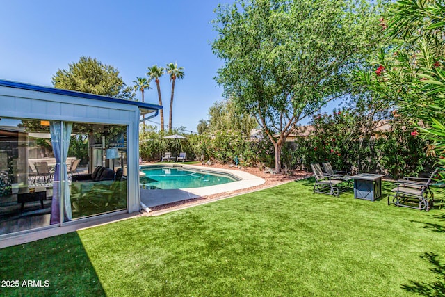 outdoor pool with a yard and fence