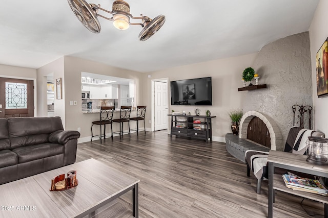 living area featuring baseboards and wood finished floors