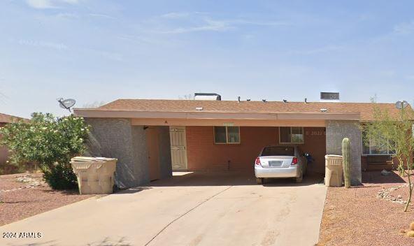 ranch-style home with a carport