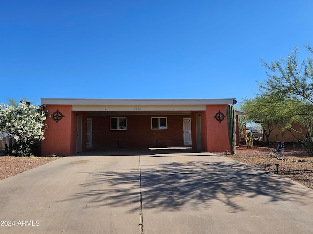 view of front of property featuring a carport