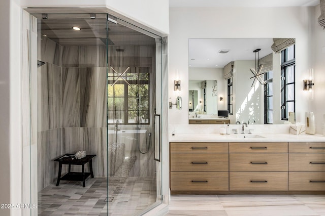 bathroom featuring a stall shower and vanity