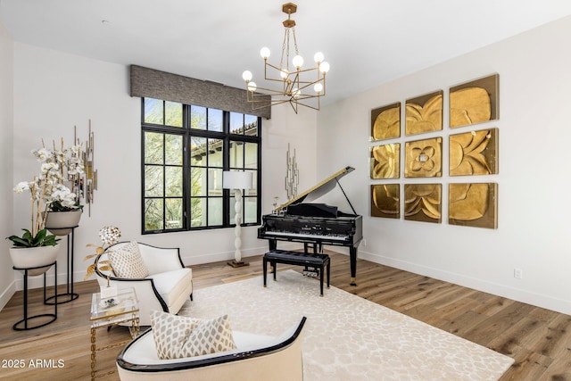 sitting room with baseboards and wood finished floors