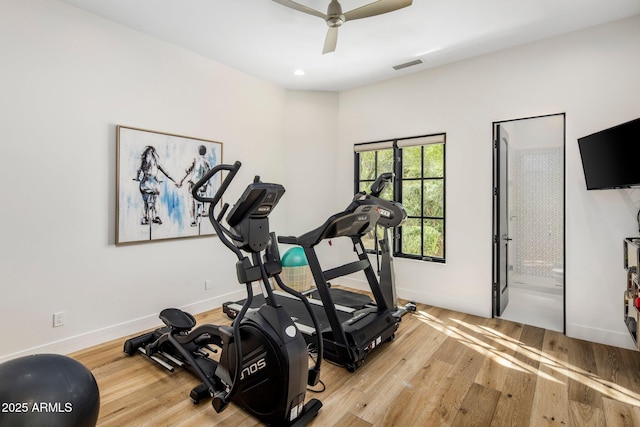 exercise area with visible vents, ceiling fan, baseboards, and wood finished floors