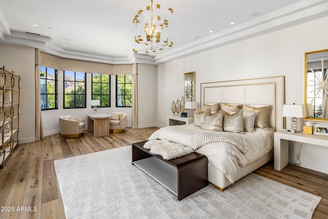 bedroom with light wood-type flooring, baseboards, and a notable chandelier