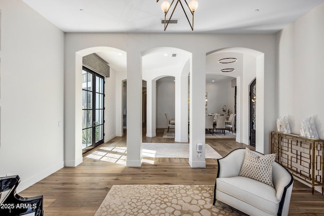 entrance foyer featuring wood finished floors, visible vents, and baseboards