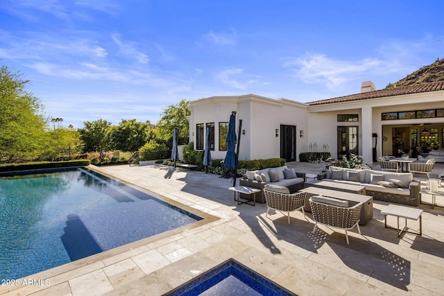 pool featuring a patio area and an outdoor living space