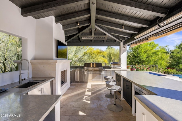 view of patio / terrace featuring exterior kitchen, a grill, and a sink