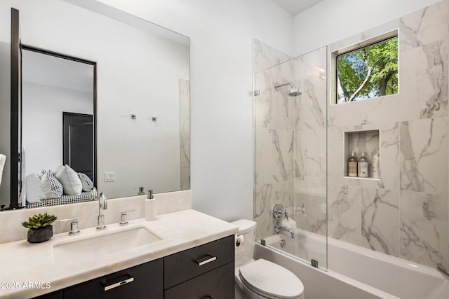 bathroom featuring vanity, bathtub / shower combination, and toilet