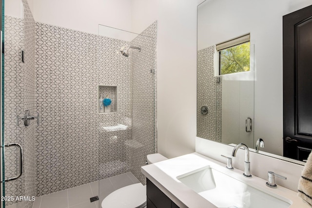 bathroom featuring a stall shower, vanity, and toilet