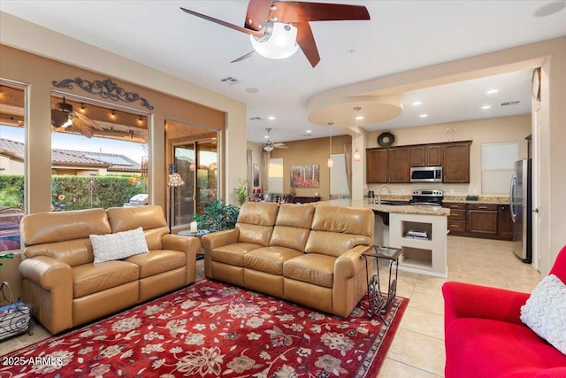 tiled living room featuring sink