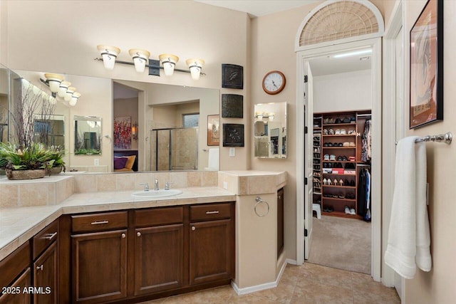 bathroom featuring vanity, tile patterned floors, and a shower with shower door