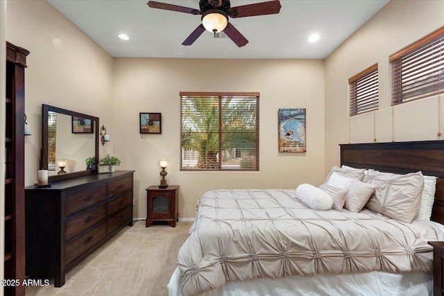 bedroom featuring light carpet and ceiling fan