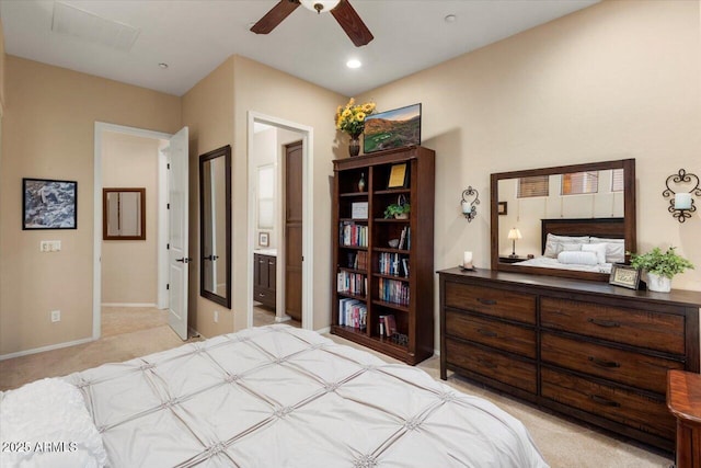 carpeted bedroom with ensuite bath and ceiling fan