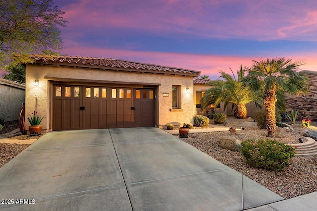 mediterranean / spanish-style home with a garage