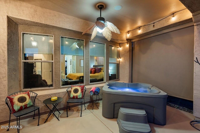 view of patio featuring ceiling fan and a hot tub