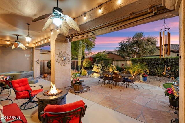 patio terrace at dusk featuring a fire pit