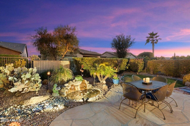 view of patio terrace at dusk