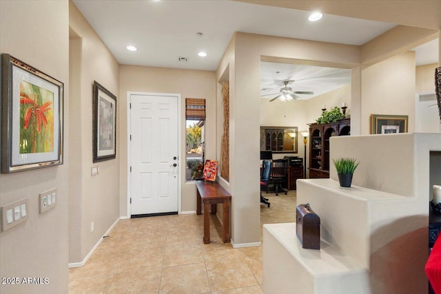 tiled entrance foyer with ceiling fan