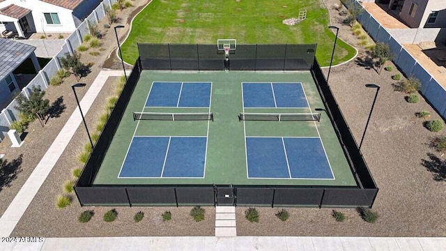 view of tennis court with basketball hoop