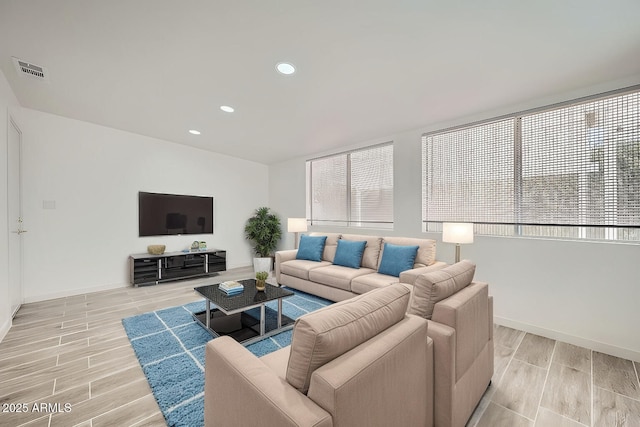 living room with baseboards, recessed lighting, visible vents, and wood tiled floor