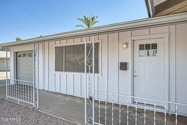 view of exterior entry featuring board and batten siding