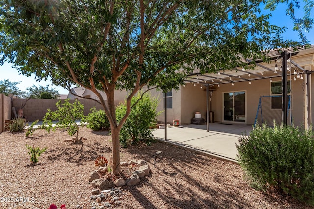 4741 E Fire Opal Ln, San Tan Valley, AZ 85143 - back of property with a fenced backyard, stucco siding, a pergola, and a patio area