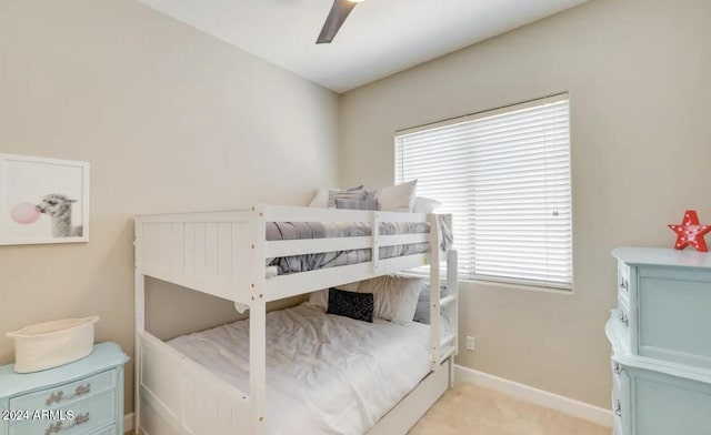 bedroom with light carpet and ceiling fan