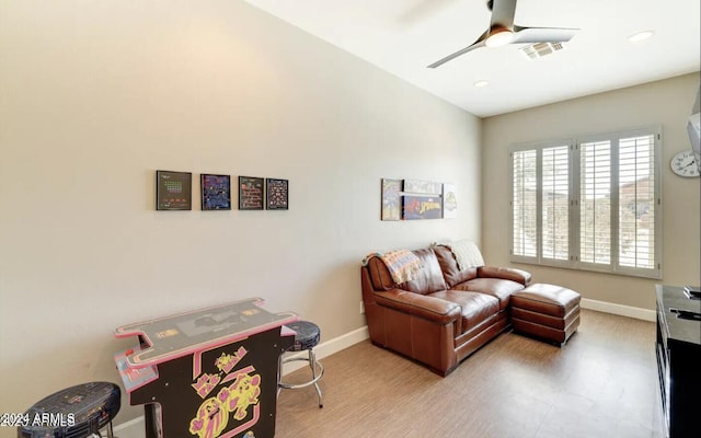 living room featuring wood-type flooring and ceiling fan